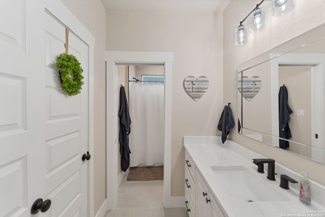 bathroom with vanity, tile patterned flooring, and walk in shower