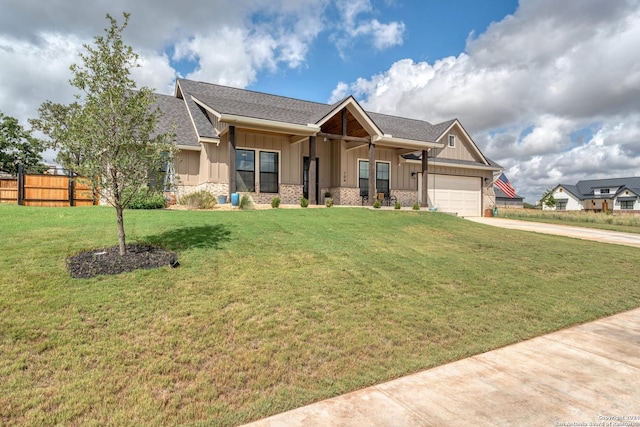 craftsman-style house featuring a garage and a front yard