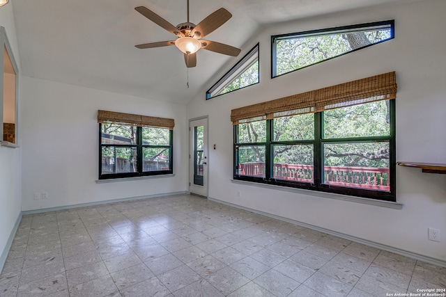 tiled spare room with ceiling fan, high vaulted ceiling, and a healthy amount of sunlight