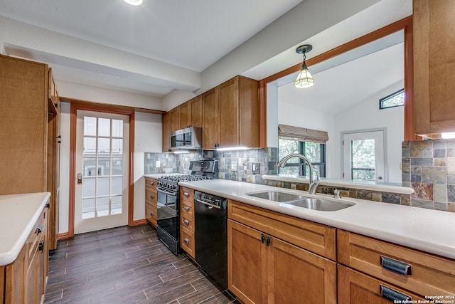 kitchen with backsplash, vaulted ceiling, double oven range, dishwasher, and sink