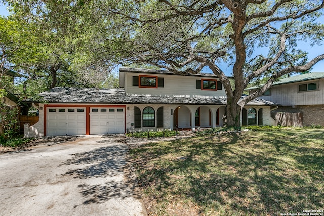 view of front of property featuring a garage and a front yard