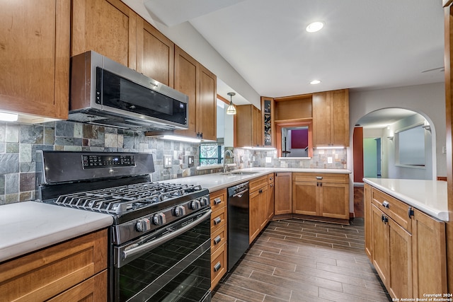 kitchen with dark hardwood / wood-style flooring, tasteful backsplash, gas range, sink, and black dishwasher