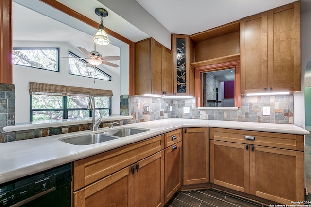 kitchen featuring black dishwasher, sink, vaulted ceiling, tasteful backsplash, and ceiling fan