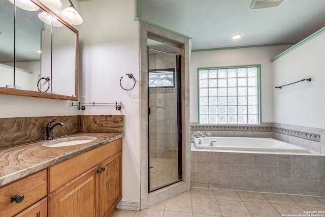 bathroom featuring independent shower and bath, vanity, and tile patterned floors