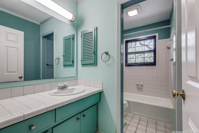 full bathroom featuring tile patterned floors, vanity, tiled shower / bath combo, and toilet