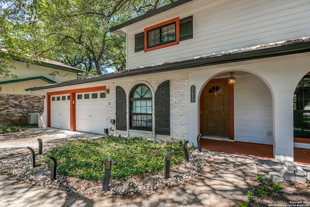 exterior space with brick siding, driveway, and an attached garage