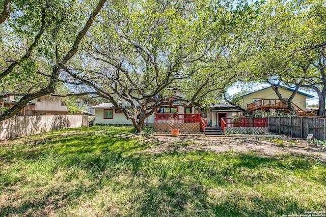 view of yard featuring fence and a wooden deck