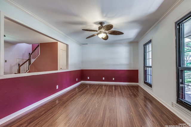 spare room with dark hardwood / wood-style flooring, crown molding, and ceiling fan