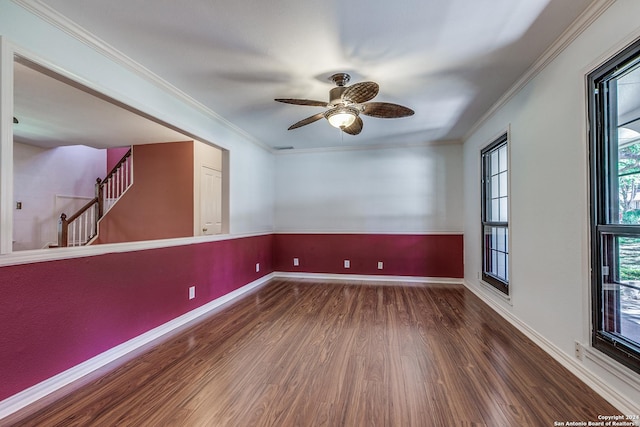 spare room with ornamental molding, a ceiling fan, stairway, and wood finished floors