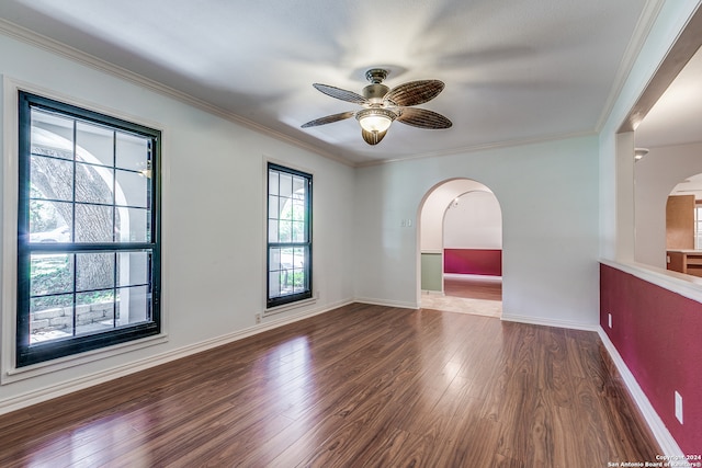 empty room with ceiling fan, wood-type flooring, and ornamental molding