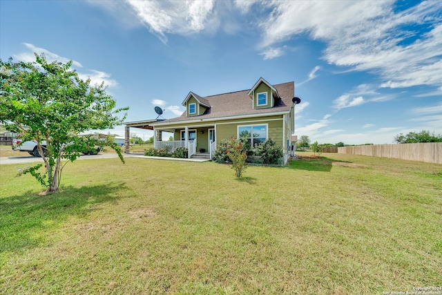 exterior space with covered porch and a front yard