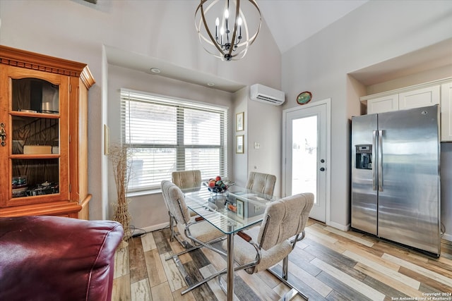 dining space featuring high vaulted ceiling, an AC wall unit, light hardwood / wood-style flooring, and an inviting chandelier