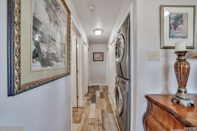 corridor featuring light hardwood / wood-style flooring and stacked washer and dryer