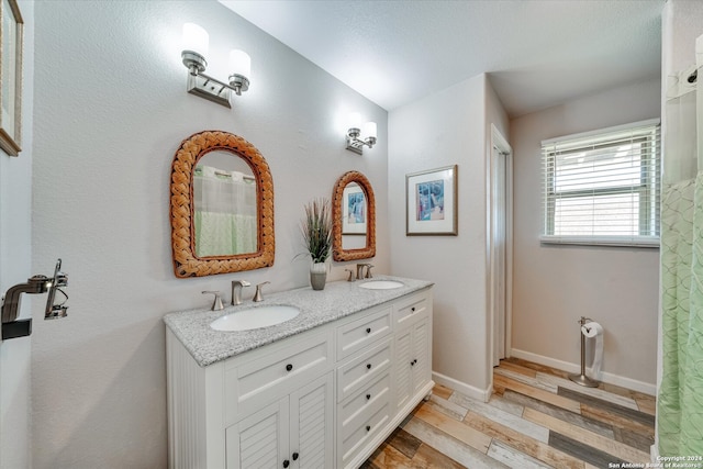 bathroom featuring dual vanity and hardwood / wood-style flooring