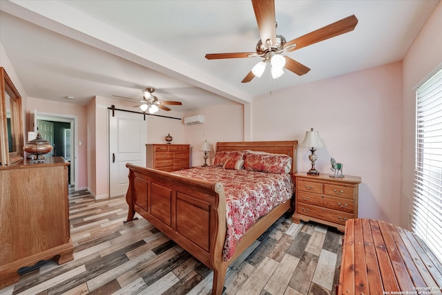 bedroom with ceiling fan, hardwood / wood-style flooring, and an AC wall unit