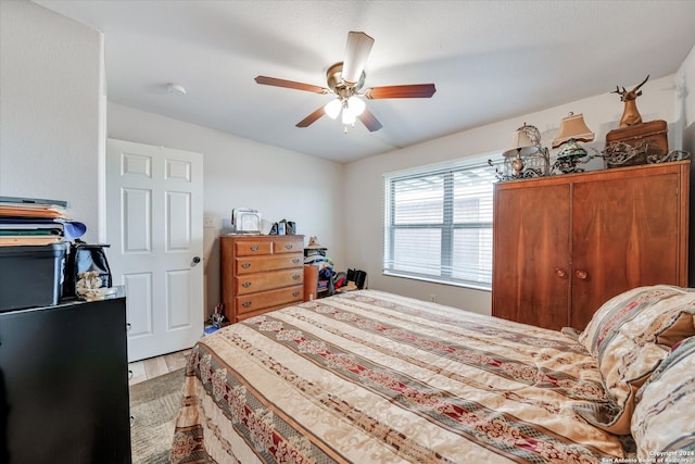 bedroom with ceiling fan and light hardwood / wood-style flooring