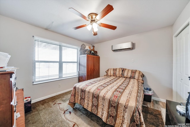 bedroom featuring a closet, ceiling fan, dark wood-type flooring, and a wall unit AC