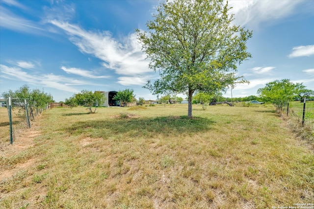 view of yard with a rural view