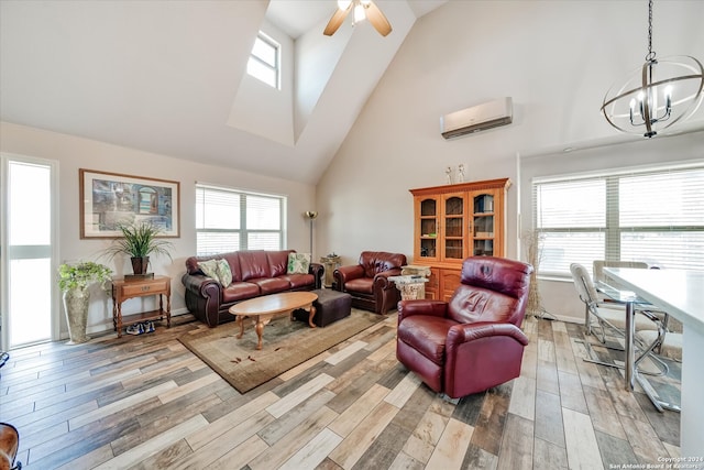 living room with light hardwood / wood-style flooring, high vaulted ceiling, ceiling fan with notable chandelier, and an AC wall unit