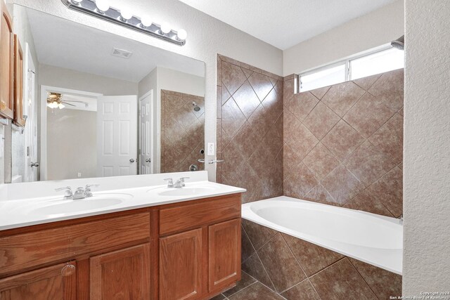 bathroom featuring ceiling fan, tile patterned flooring, a textured ceiling, and dual vanity