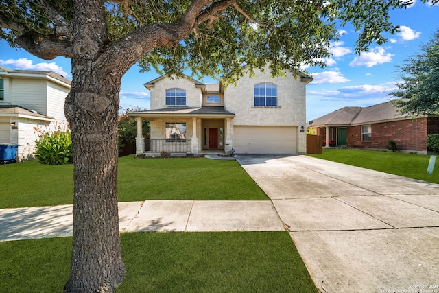 traditional-style home with concrete driveway, a porch, a front lawn, and an attached garage