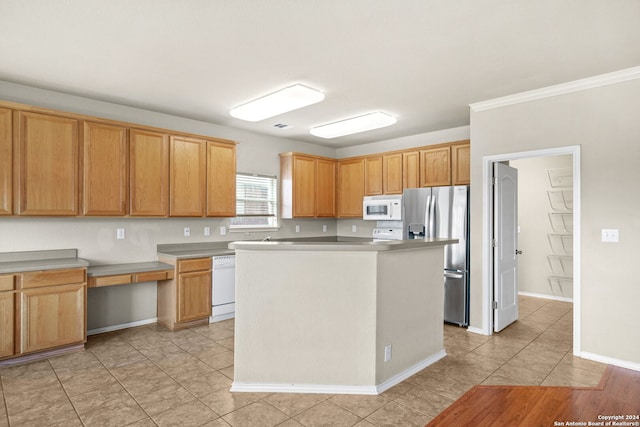 kitchen with light tile patterned flooring, white appliances, a kitchen island, baseboards, and light countertops