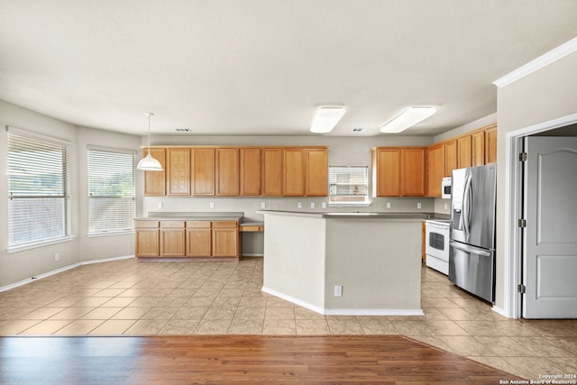 kitchen with white appliances, a kitchen island, light countertops, pendant lighting, and light tile patterned flooring