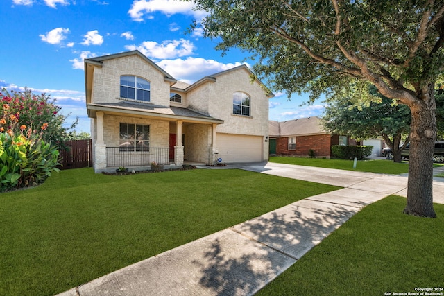 traditional-style house with a garage, concrete driveway, stone siding, covered porch, and a front lawn