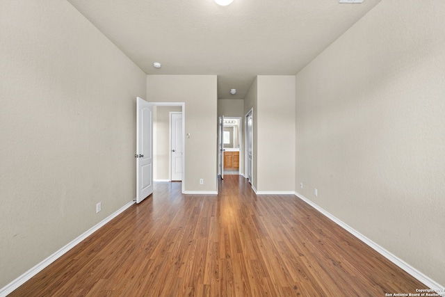 interior space with dark wood finished floors and baseboards