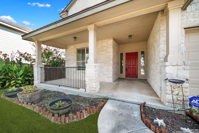 property entrance with stone siding and covered porch