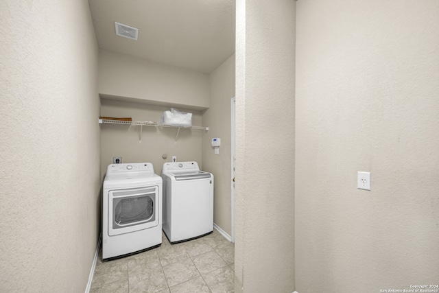 laundry room featuring laundry area, light tile patterned floors, visible vents, baseboards, and independent washer and dryer