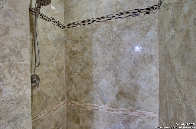 interior details with a tile shower