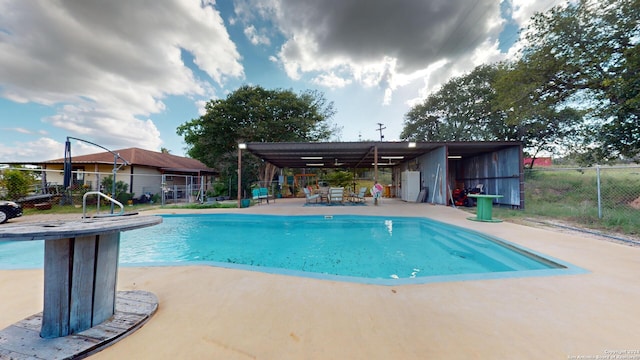 view of swimming pool with a patio