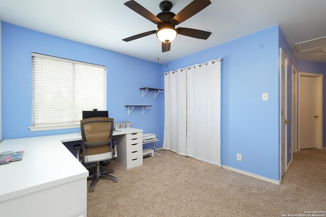 carpeted home office featuring ceiling fan