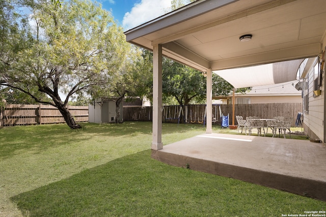 view of yard with a storage shed and a patio