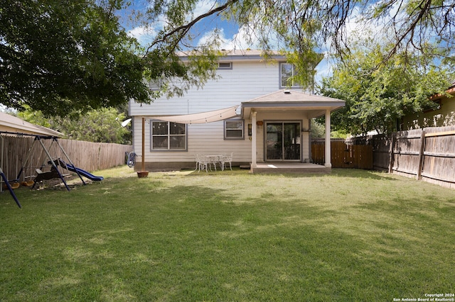 back of property featuring a patio and a yard