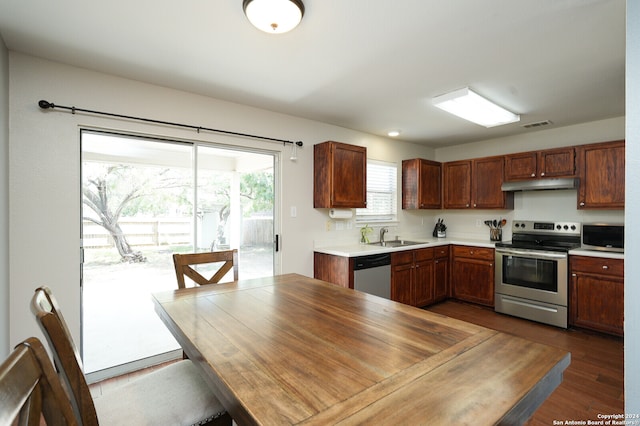 kitchen with appliances with stainless steel finishes, sink, and wood-type flooring