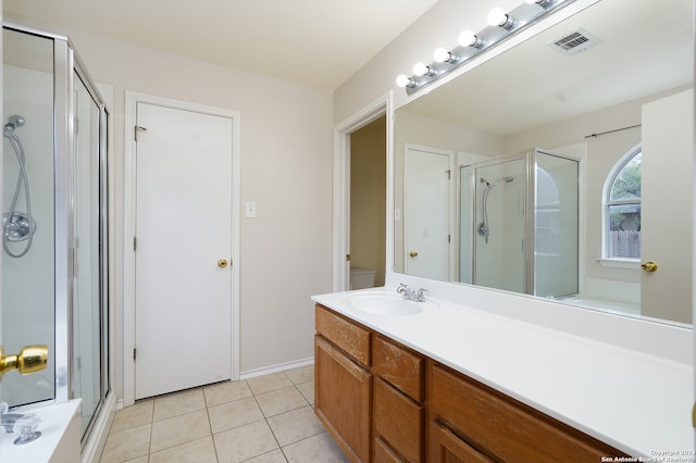 bathroom featuring tile patterned flooring, an enclosed shower, and vanity