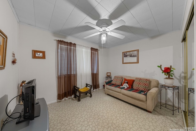 tiled living room featuring ceiling fan and crown molding