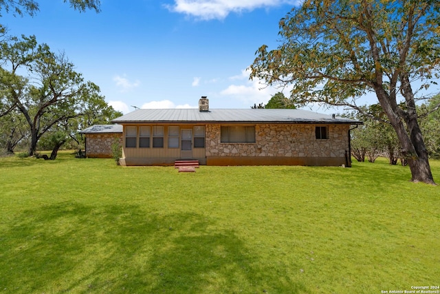 back of house with a yard