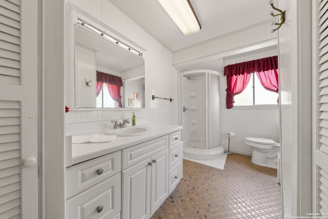 bathroom featuring tile patterned floors, toilet, vanity, and a wealth of natural light