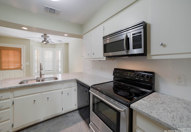 kitchen featuring sink, light tile patterned floors, appliances with stainless steel finishes, decorative backsplash, and ceiling fan