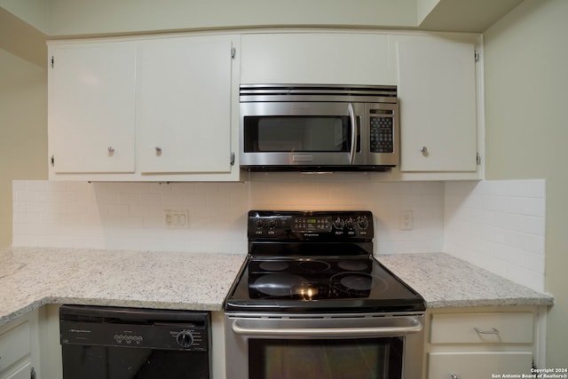 kitchen featuring tasteful backsplash, white cabinetry, appliances with stainless steel finishes, and light stone counters