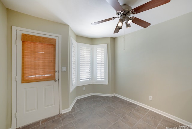 interior space with ceiling fan and light tile patterned floors