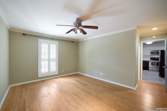 tiled spare room featuring ceiling fan and crown molding