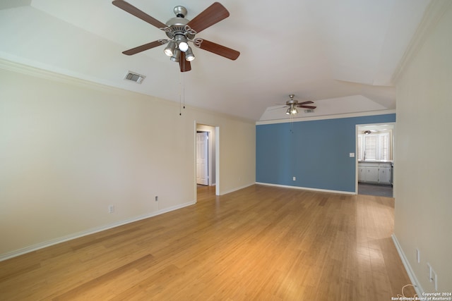 unfurnished room featuring ceiling fan, light hardwood / wood-style floors, ornamental molding, and lofted ceiling