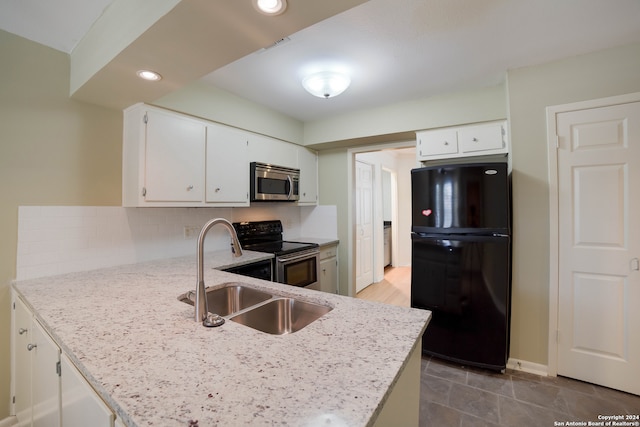 kitchen featuring white cabinetry, light tile patterned floors, stainless steel appliances, and light stone countertops