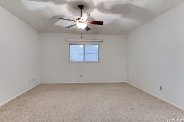 unfurnished room with ceiling fan, light colored carpet, and a textured ceiling