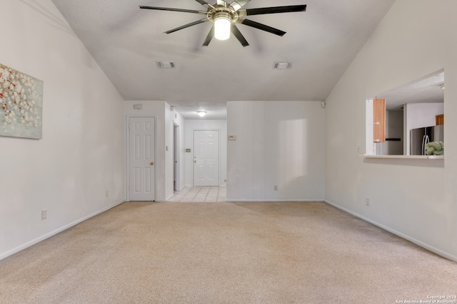 tiled spare room featuring lofted ceiling and ceiling fan