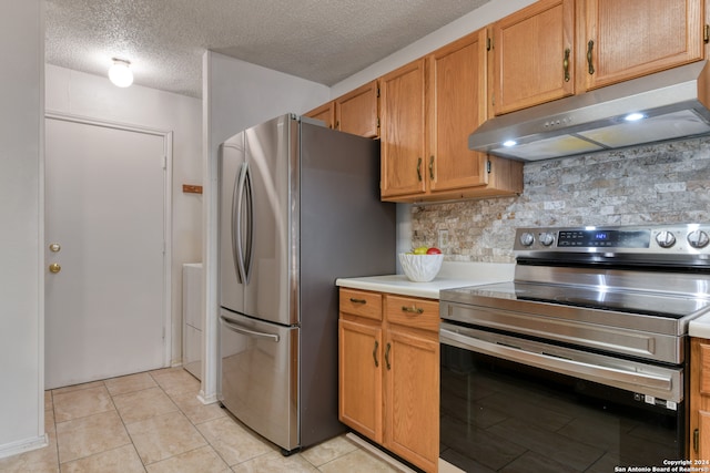 kitchen with a textured ceiling, backsplash, stainless steel appliances, and light tile patterned flooring